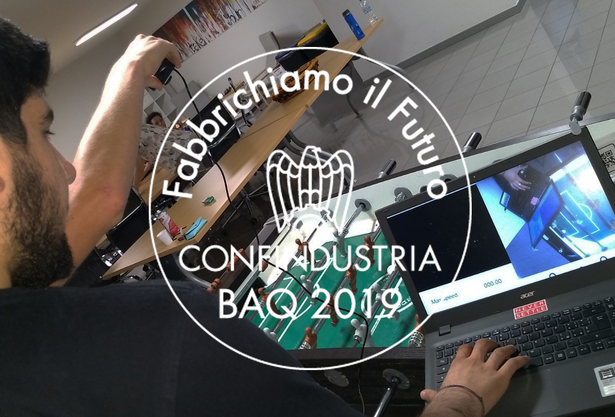 Mail dei ragazzi che lavorano al calcio balilla e il logo sovrapposto del BAQ 2019